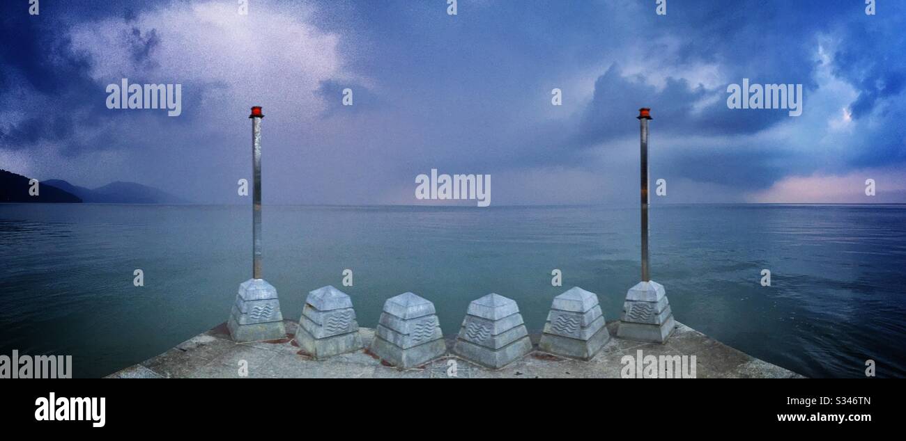A morning rain squall over the ocean at Batu Ferringhi, Penang, Malaysia - Smartphone Captured Stock Image