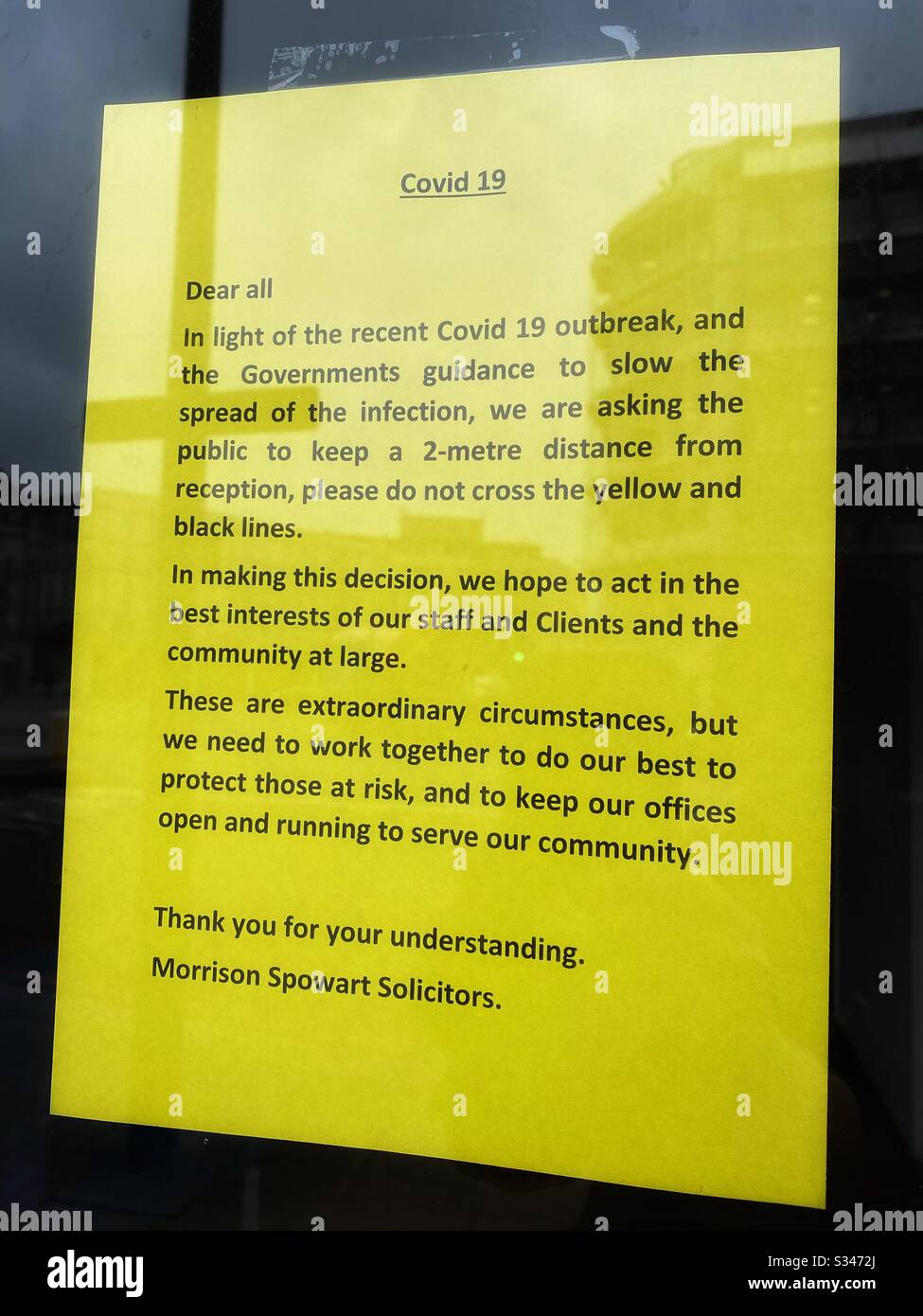 A sign in the window of a solicitors in South London outlining social distancing on the premises, March 18 2020 - Smartphone Captured Stock Image