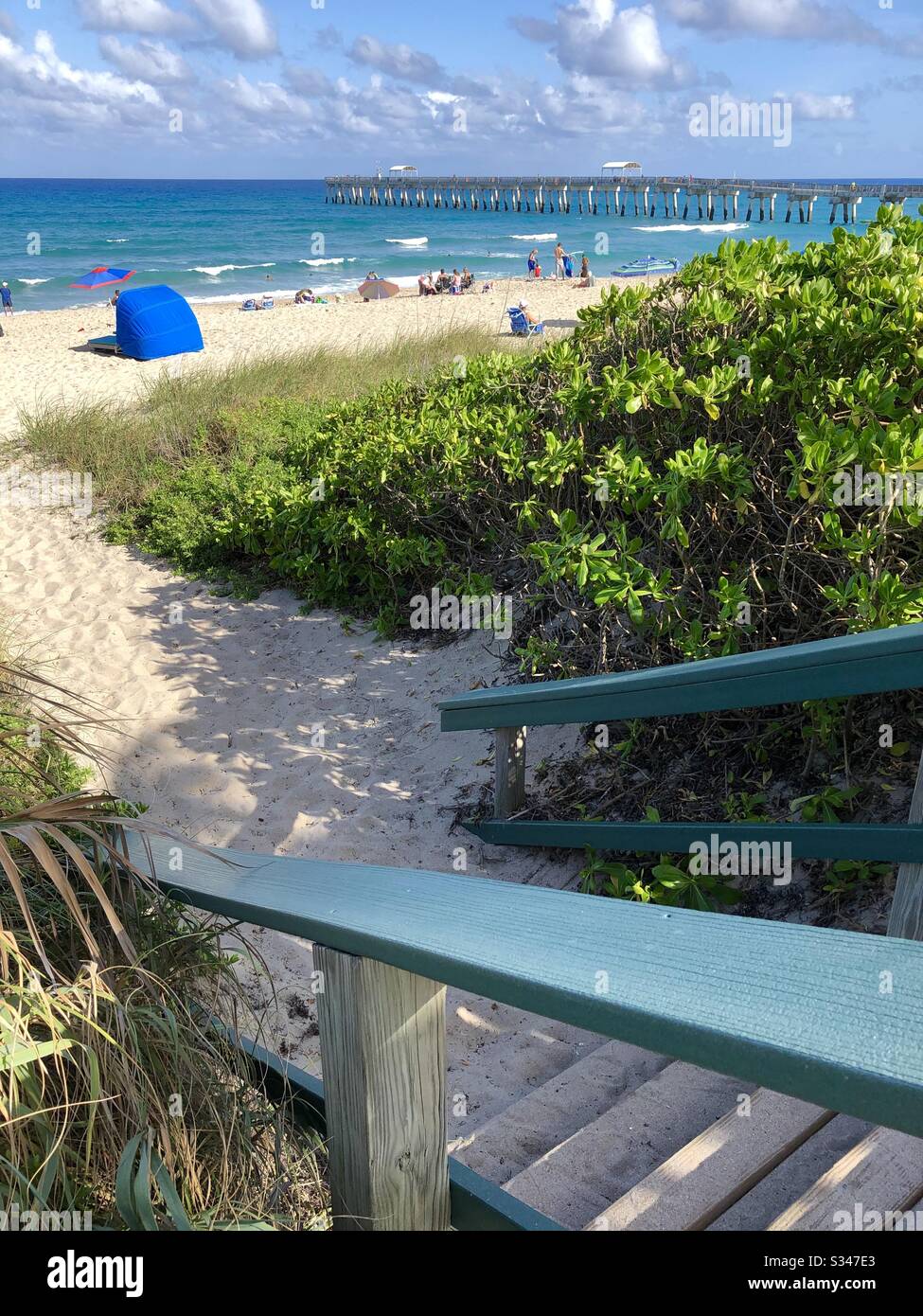 Steps leading down to the beach and the ocean at the Lake Worth Beach pier and Beach, Florida. - Smartphone Captured Stock Image