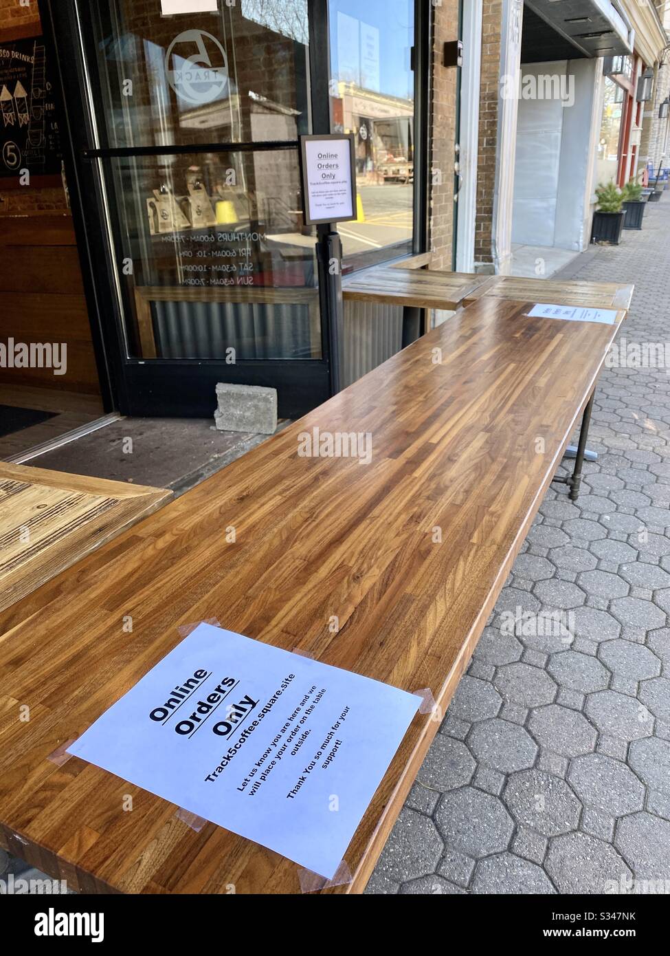 Coronavirus panic creates new shopping experiences. Pickup order outside of store. - Smartphone Captured Stock Image