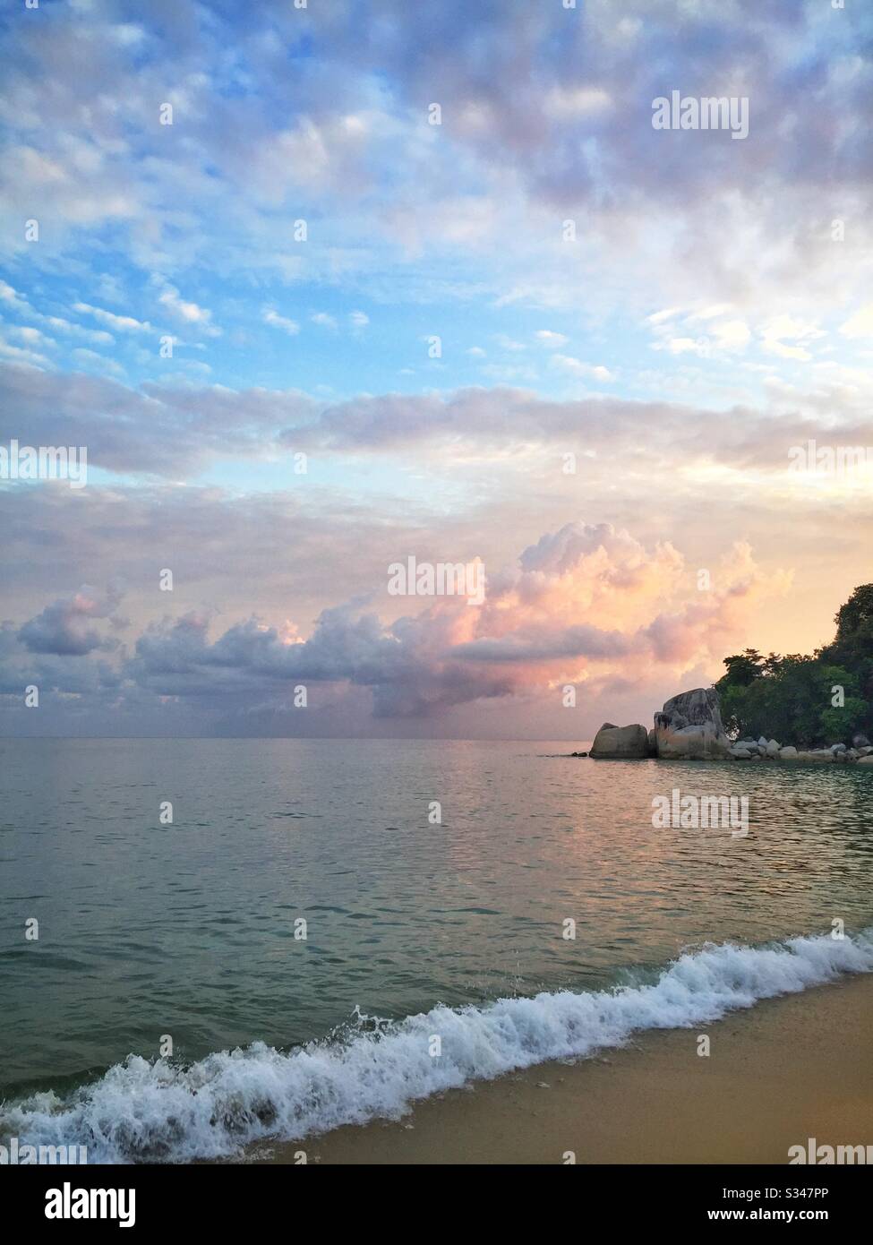 Sunrise at the southern end of Batu Ferringhi Beach, Penang, Malaysia - Smartphone Captured Stock Image