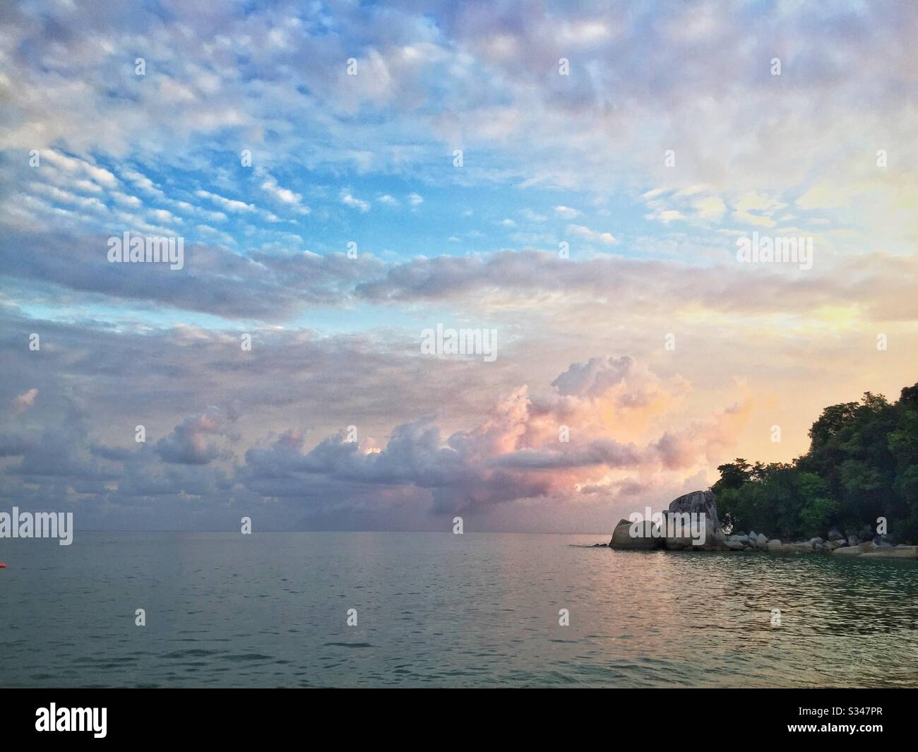 Sunrise at the southern end of Batu Ferringhi Beach, Penang, Malaysia - Smartphone Captured Stock Image