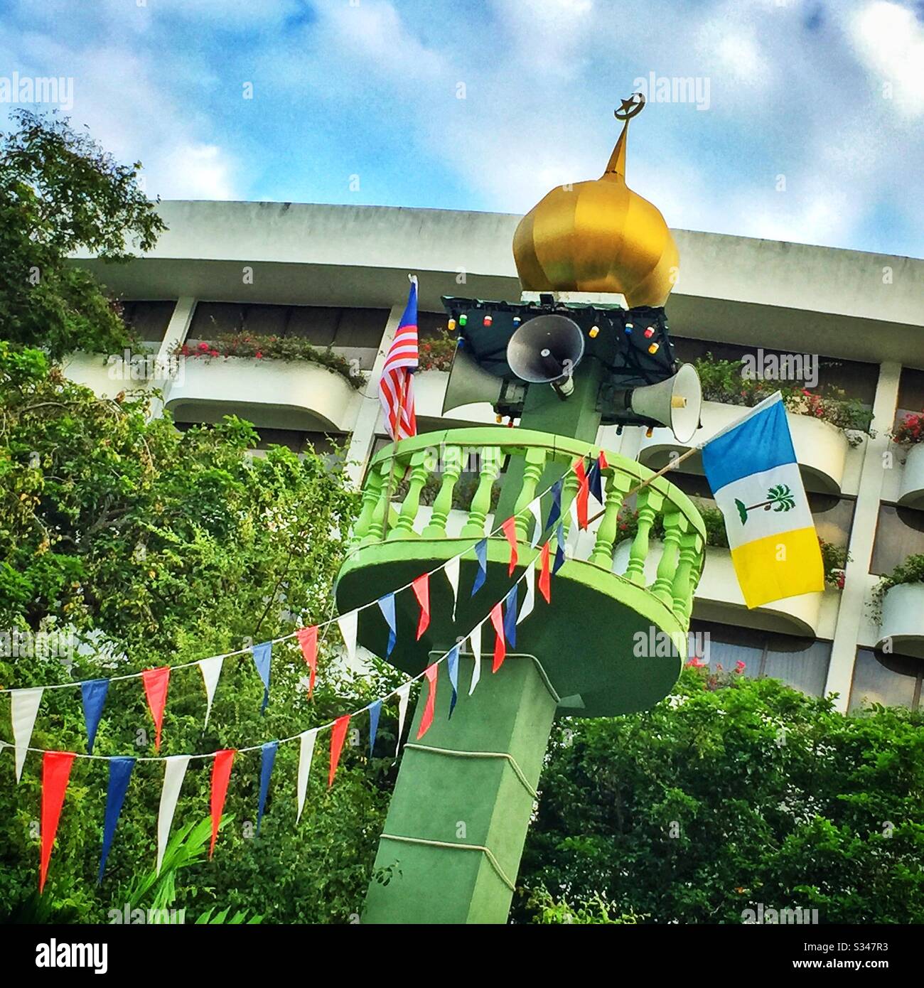 The minaret of a mosque fitted with loudspeakers for the broadcast of the adhan, or call to prayer, Batu Ferringhi, Penang, Malaysia - Smartphone Captured Stock Image
