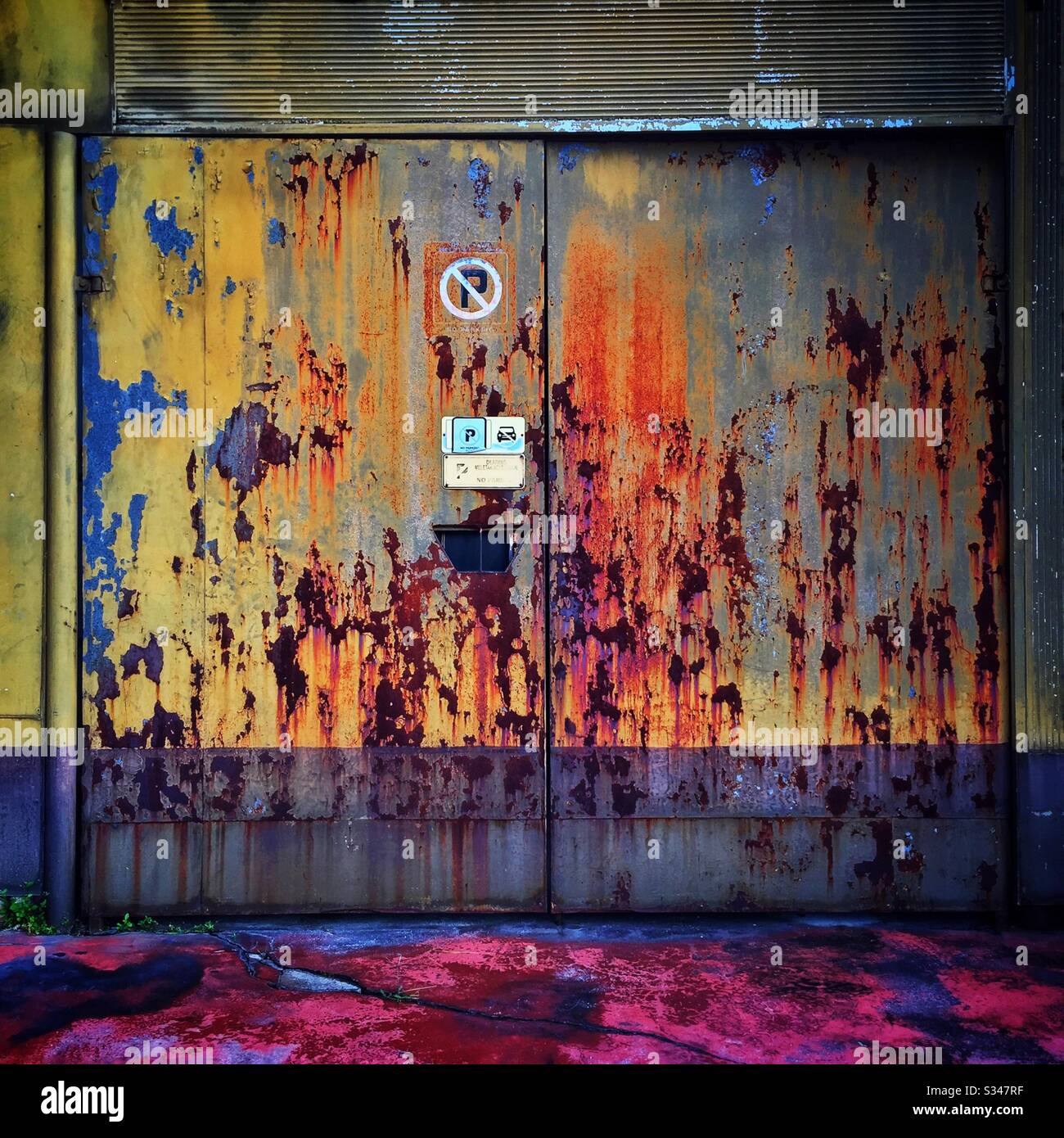 A rusting painted garage door in Batu Ferringhi, Penang, Malaysia - Smartphone Captured Stock Image