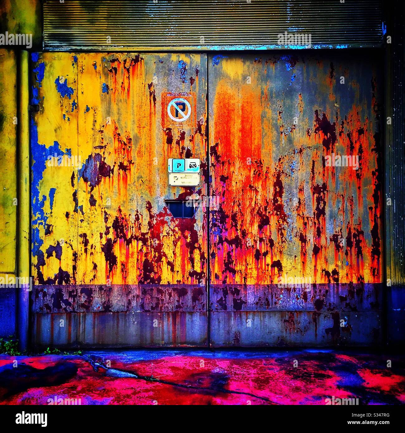 A rusting painted garage door in Batu Ferringhi, Penang, Malaysia - Smartphone Captured Stock Image