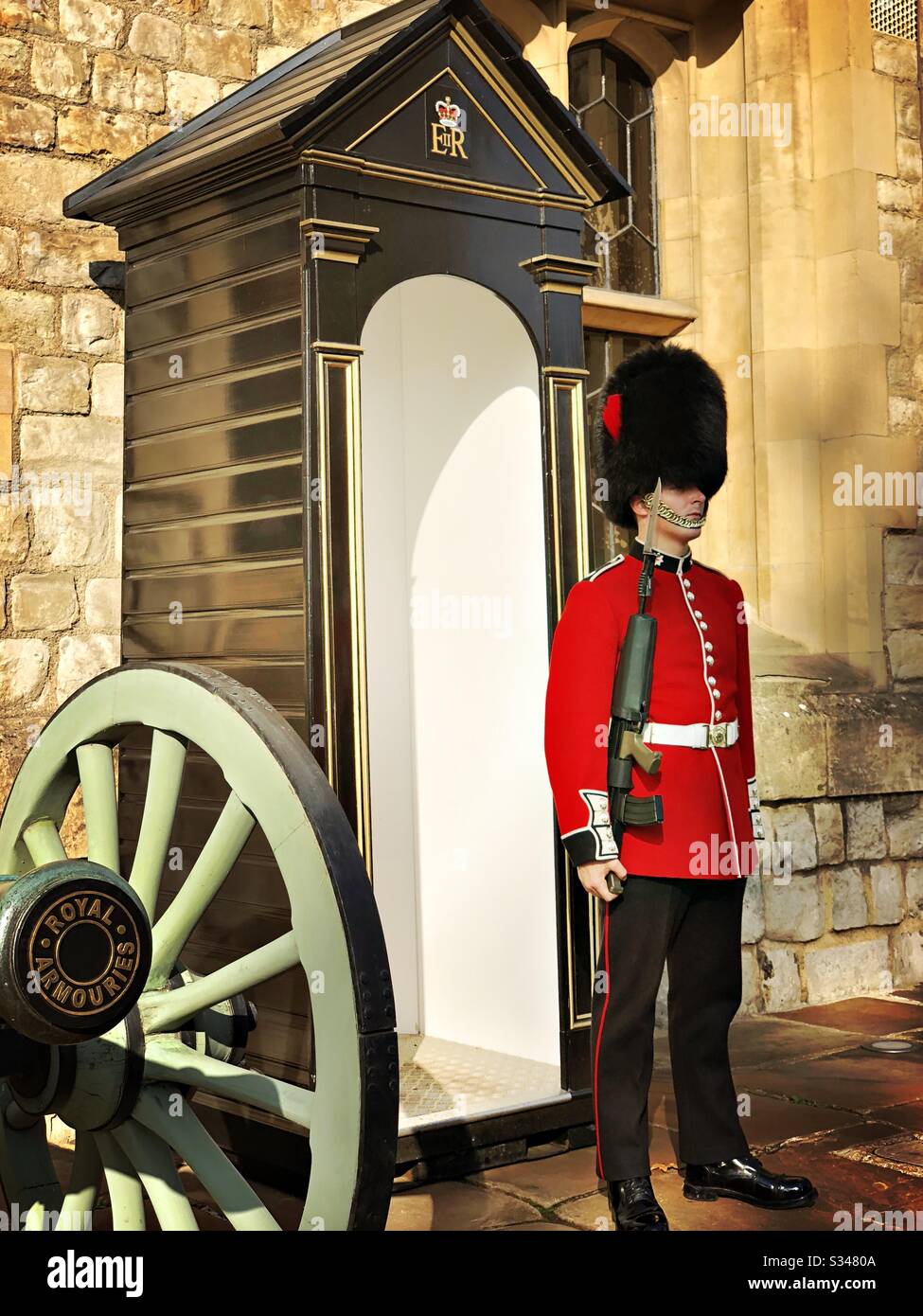 A Scots Guard sentry outside the Jewel House with cannon. Waterloo Block at the Tower of London. UNESCO World Heritage Site. - Smartphone Captured Stock Image