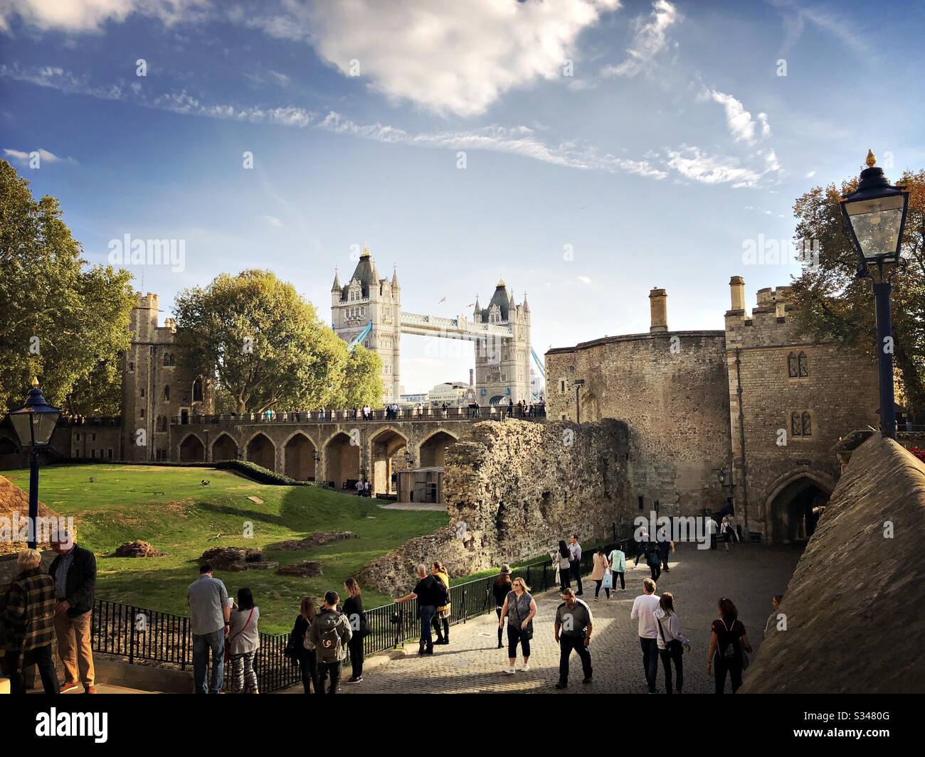 A view of Tower Bridge from within the Tower of London. Medieval castle and fortress complex within Tower Hamlets. - Smartphone Captured Stock Image