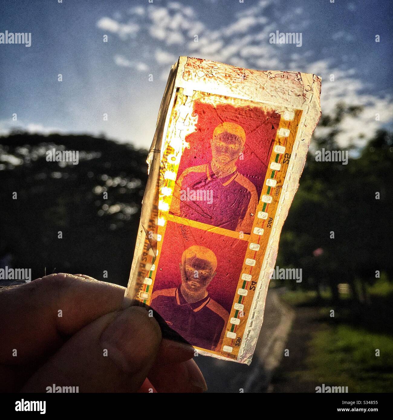Film negatives for ID photographs found in the street, Batu Ferringhi, Penang, Malaysia - Smartphone Captured Stock Image
