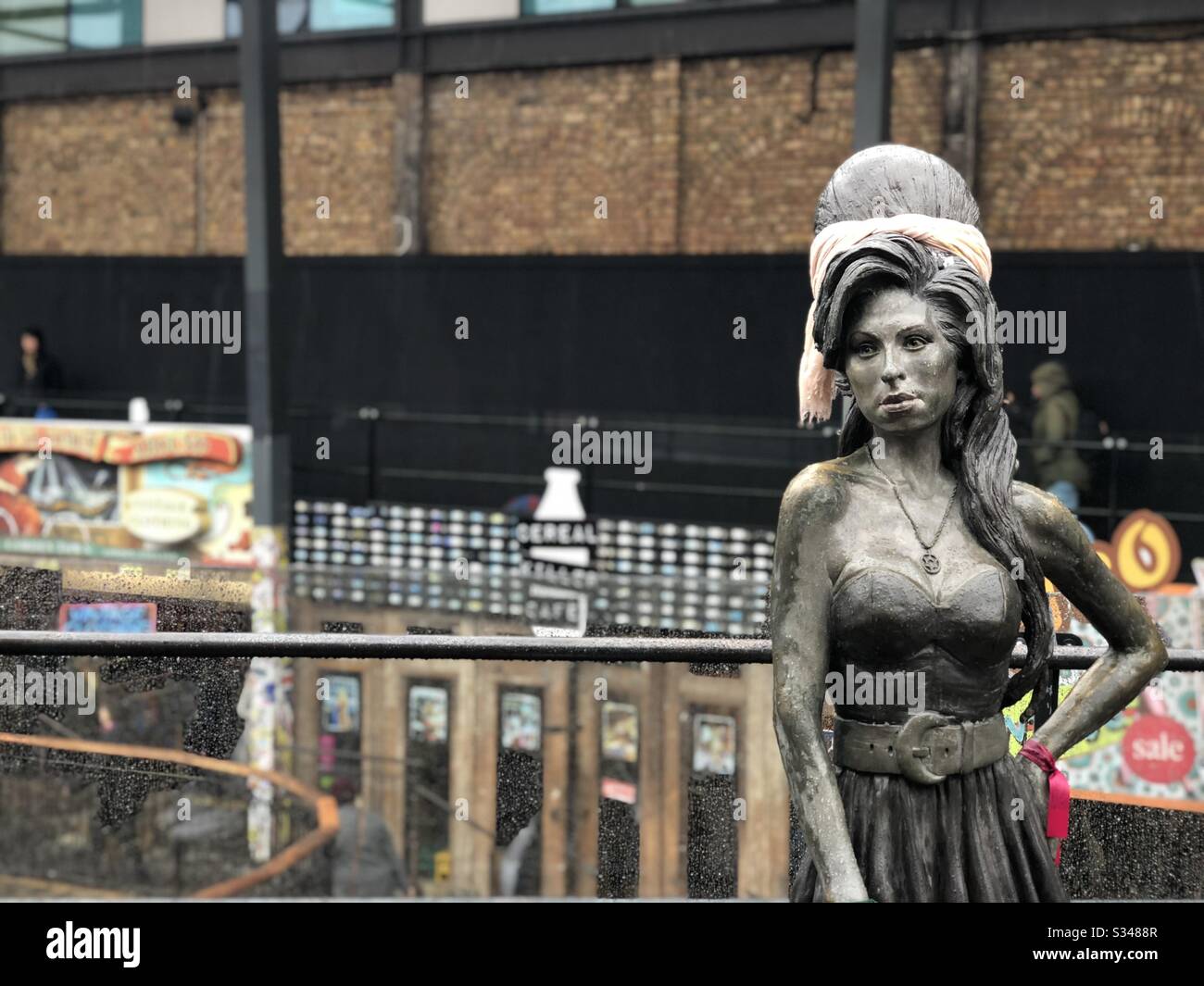Bronze statue of British singer Amy Winehouse. Memorial at Stables Market, Camden Town, London - Smartphone Captured Stock Image