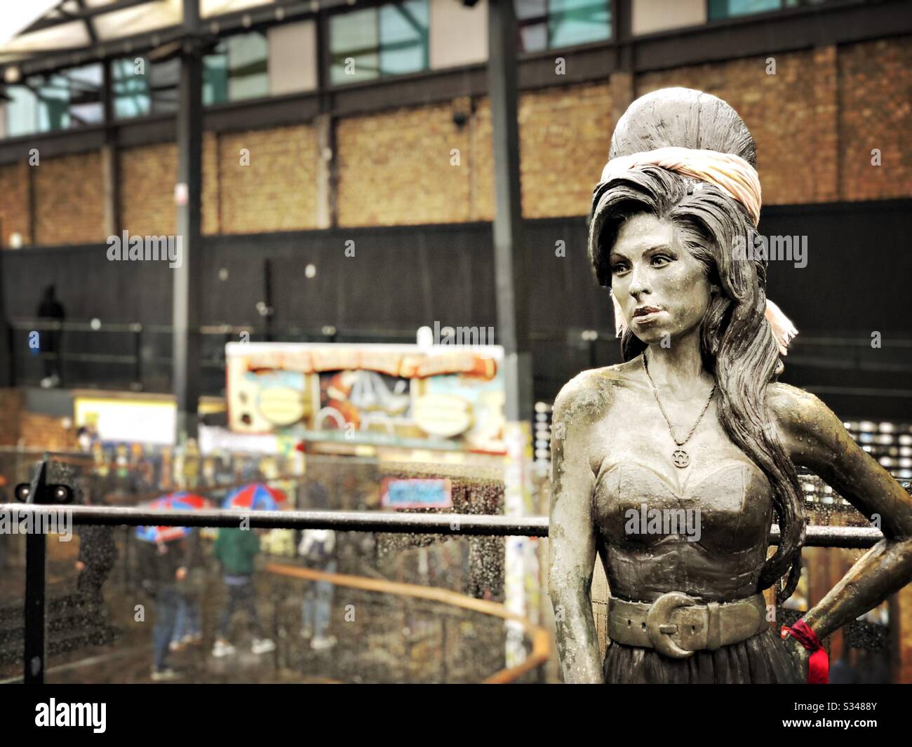 Bronze statue of British singer Amy Winehouse at Stables Market, Camden Town, London. Copy space to left. - Smartphone Captured Stock Image