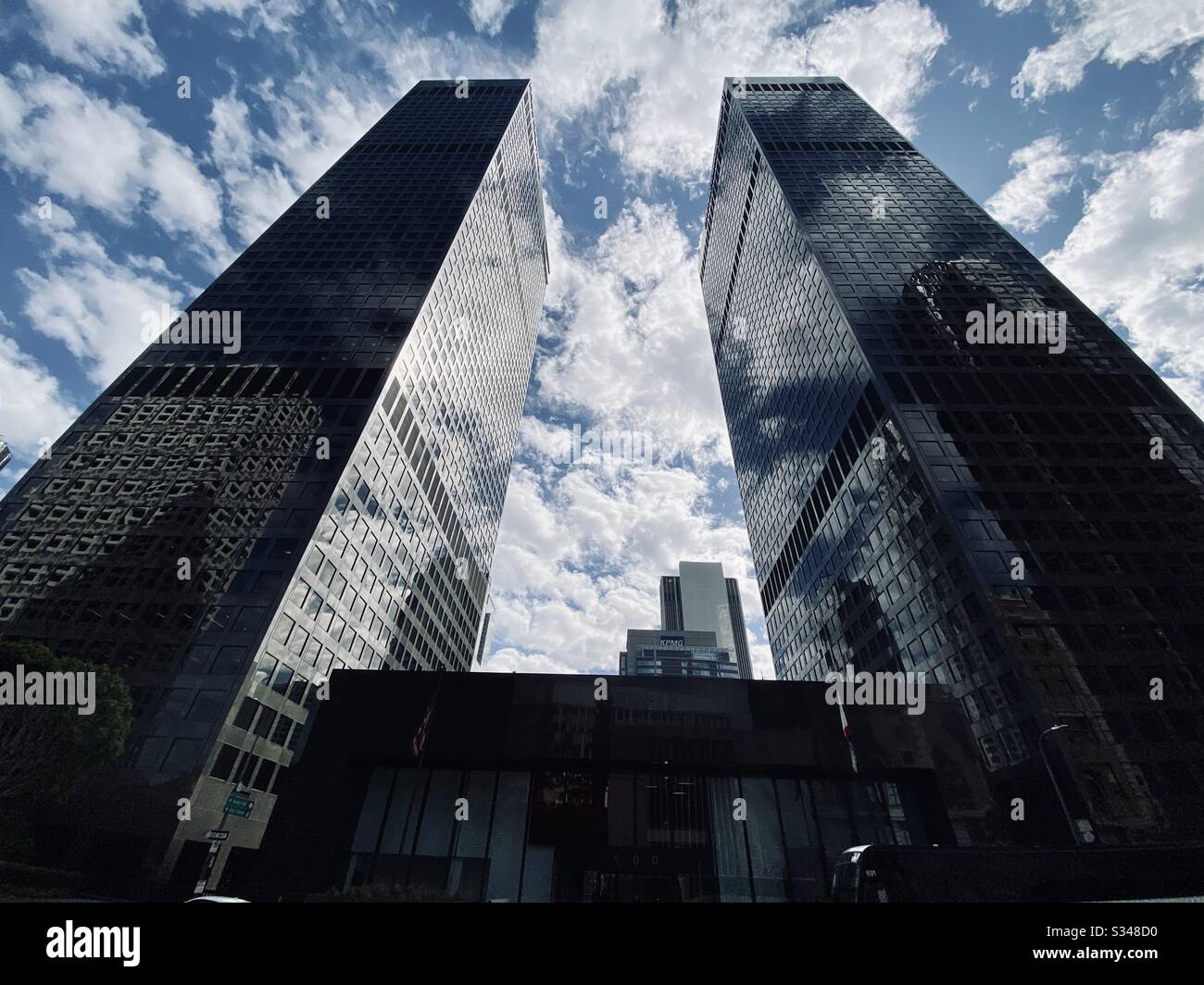 LOS ANGELES, CA, FEB 2020: twin skyscrapers silhouetted against a cloudy sky at City National Plaza in the Financial District of Downtown - Smartphone Captured Stock Image