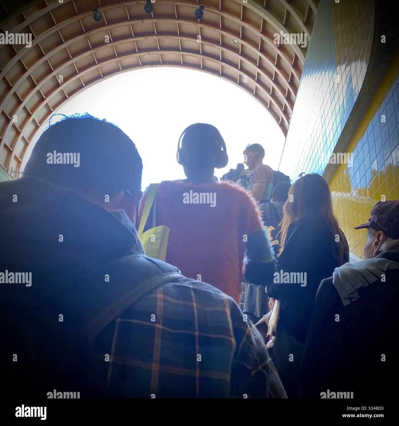 LOS ANGELES, CA, FEB 2020: backlit passengers on escalator leading up, out of North Hollywood Station on the LA Metro Red Line - Smartphone Captured Stock Image