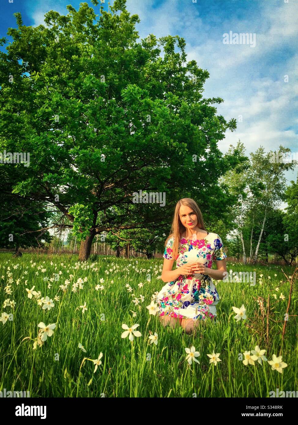 Young woman on a field of daffodils - Smartphone Captured Stock Image