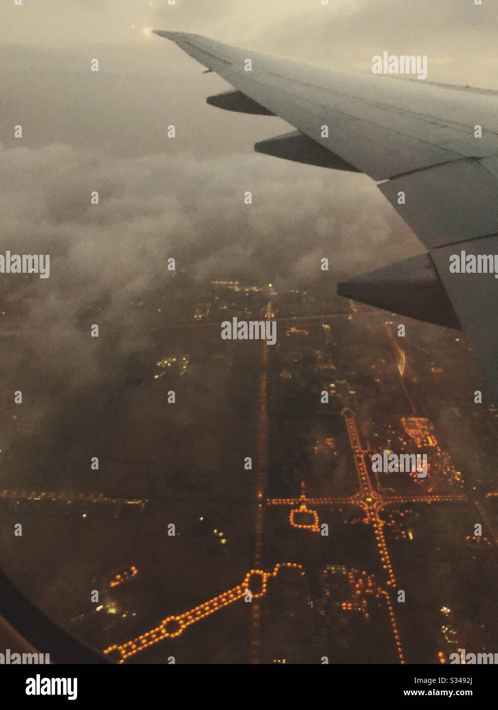 An Emirates 777 plane flying into Dubai International Airport Stock Photo