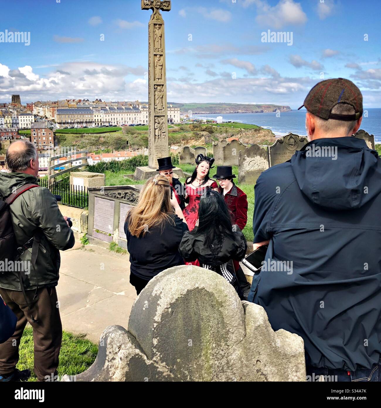 Photographers gather round a group of people dressed in costume during the Whitby Goth Weekend cosplay event - Smartphone Captured Stock Image