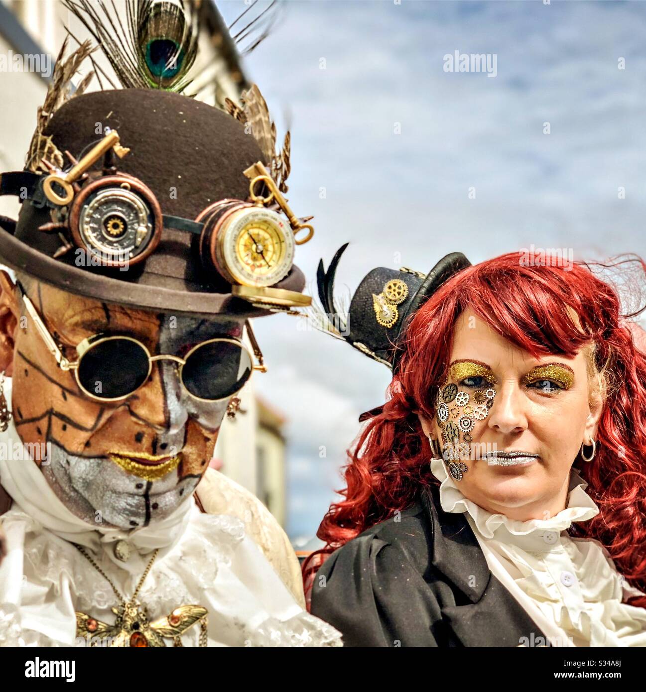 People in creative costumes during a cosplay event. Whitby Goth Weekend. Man and woman steampunk couple - Smartphone Captured Stock Image