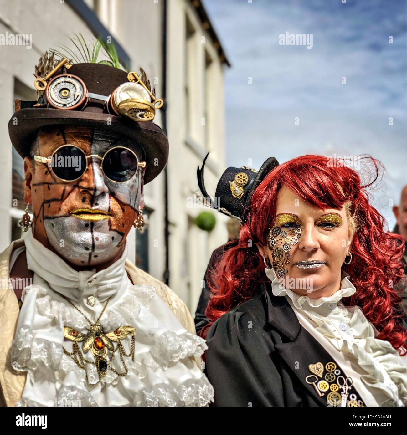 People in creative costumes during a cosplay event. Whitby Goth Weekend. Man and woman steampunk couple - Smartphone Captured Stock Image