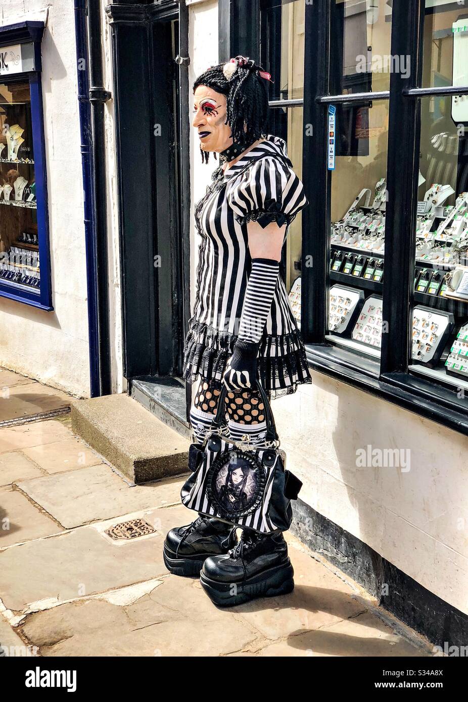 Person in a creative costume during a cosplay event. Whitby Goth Weekend. Drag queen in goth - Smartphone Captured Stock Image