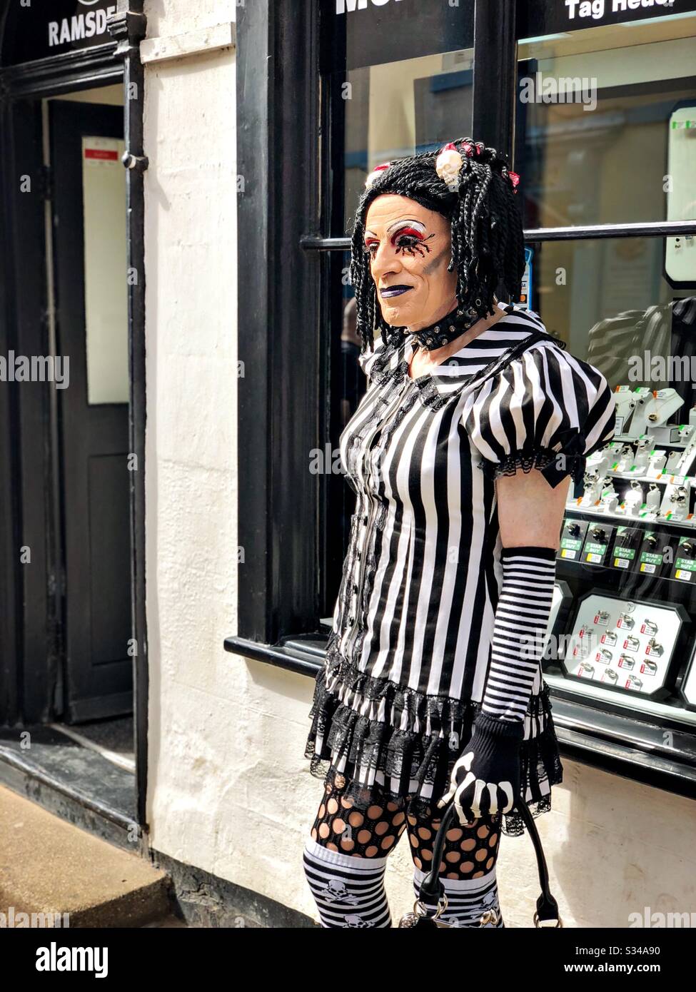 Person in a creative costume during a cosplay event. Whitby Goth Weekend. Drag queen dressed as goth - Smartphone Captured Stock Image