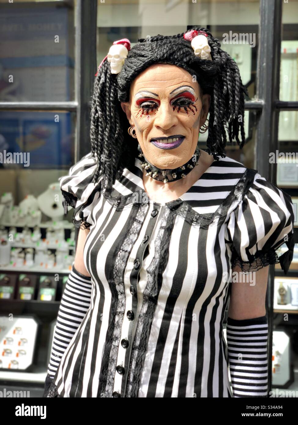 Person in a creative costume during a cosplay event. Whitby Goth Weekend. Front portrait of drag queen dressed in goth - Smartphone Captured Stock Image