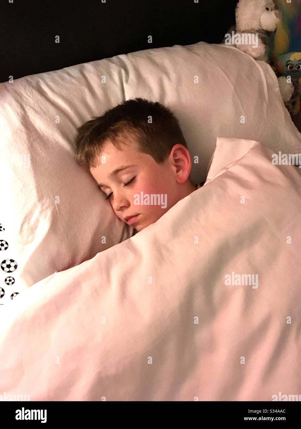 Child asleep in bed Stock Photo