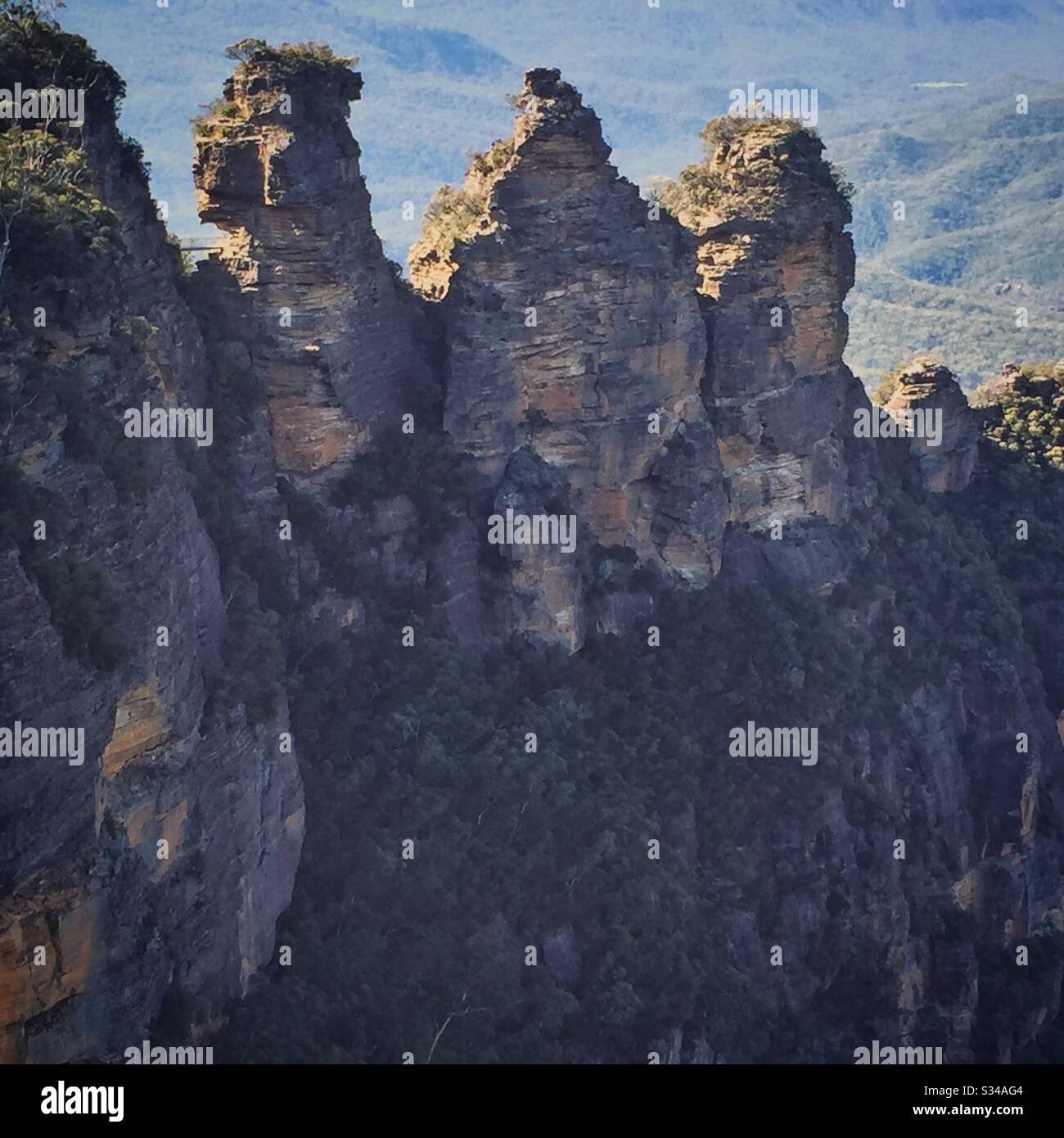 Morning sun backlights the Three Sisters in the Blue Mountains, National Park, NSW, Australia - Smartphone Captured Stock Image