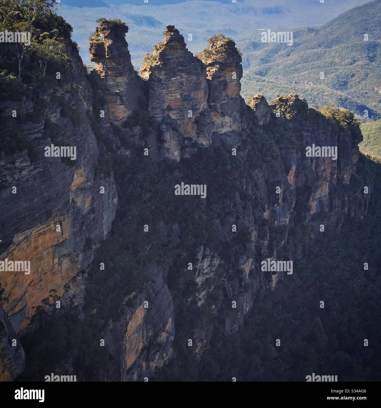 Morning sun backlights the Three Sisters in the Blue Mountains, National Park, NSW, Australia - Smartphone Captured Stock Image
