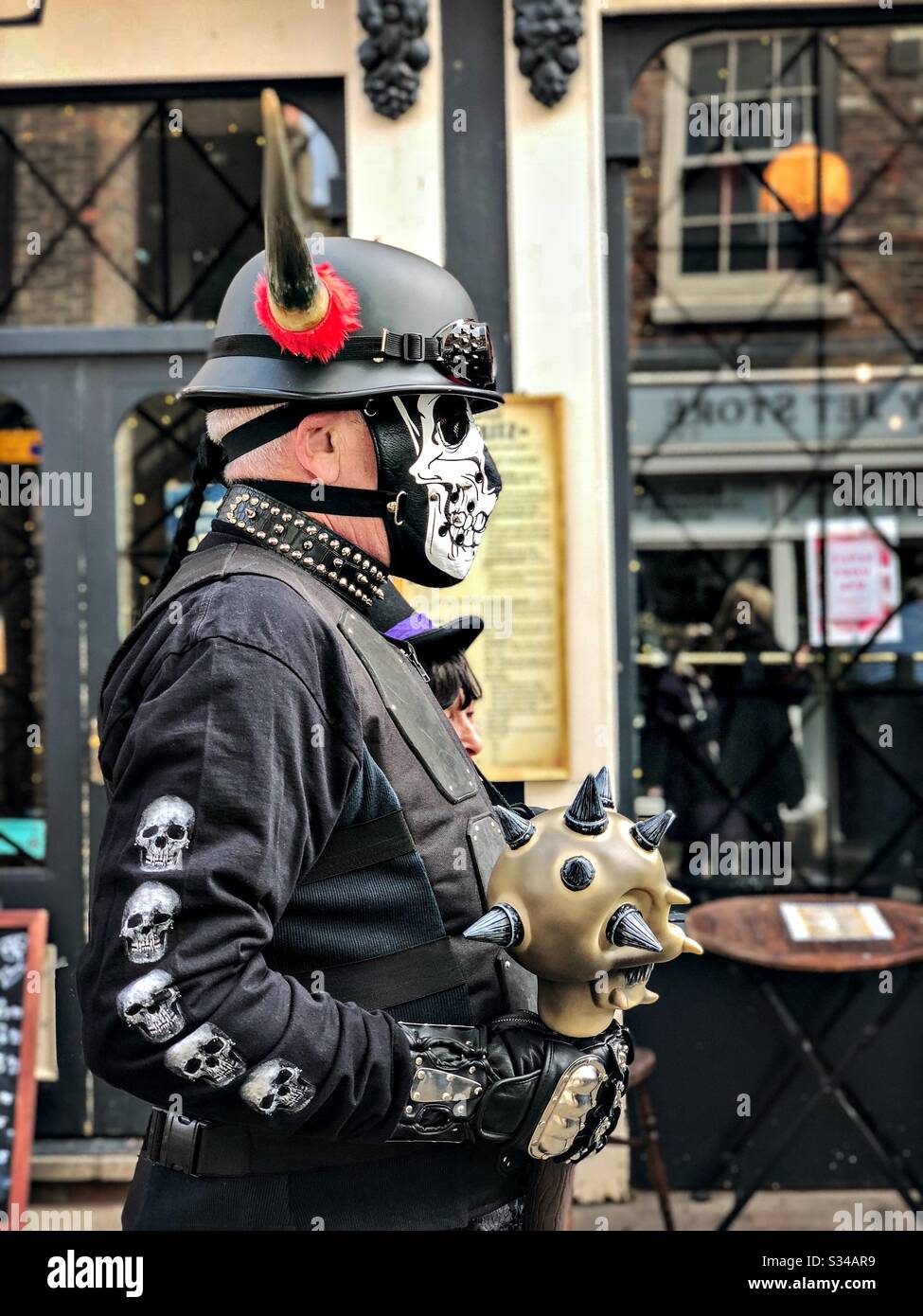 People in creative costumes during a cosplay event. Whitby Goth Weekend. Man wears horns - Smartphone Captured Stock Image