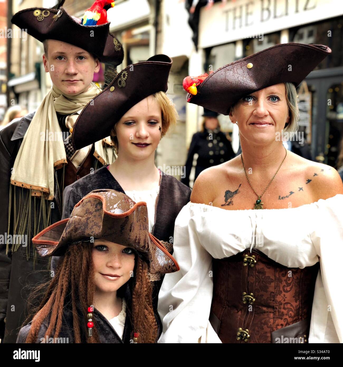 People in a creative costume during a cosplay event. Whitby Goth Weekend. Family with mother, children, siblings all dress as pirates - Smartphone Captured Stock Image