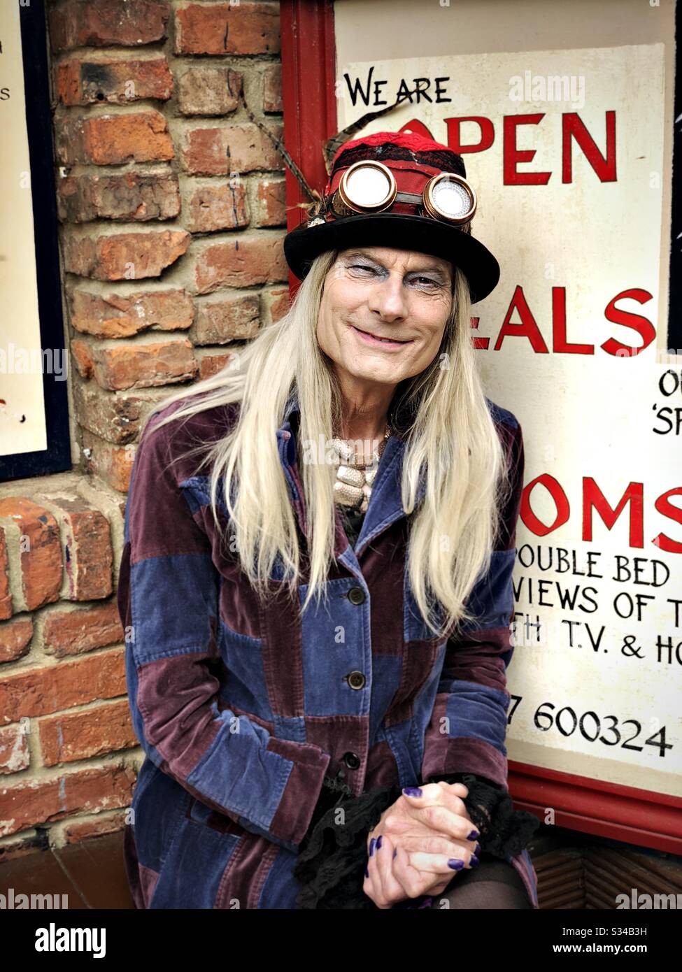 Person in a creative costume during a cosplay event. Whitby Goth Weekend. Steampunk portrait - Smartphone Captured Stock Image