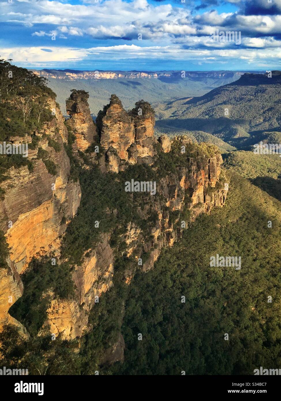Late afternoon sunlight Illuminates the Three Sisters, Mount Solitary and the Jamison Valley in the Blue Mountains, National Park, NSW, Australia - Smartphone Captured Stock Image
