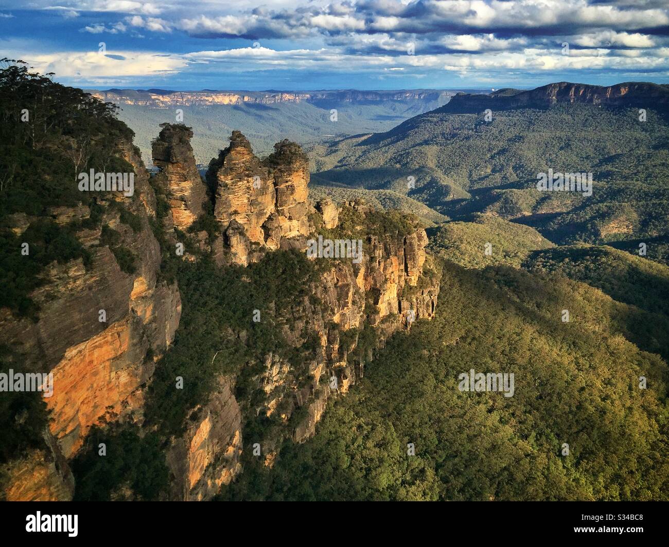 Late afternoon sunlight Illuminates the Three Sisters, Mount Solitary and the Jamison Valley in the Blue Mountains, National Park, NSW, Australia - Smartphone Captured Stock Image