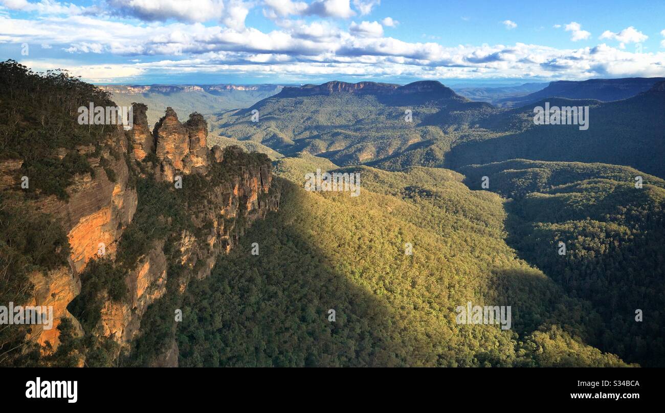 Late afternoon sunlight Illuminates the Three Sisters, Mount Solitary and the Jamison Valley in the Blue Mountains, National Park, NSW, Australia - Smartphone Captured Stock Image