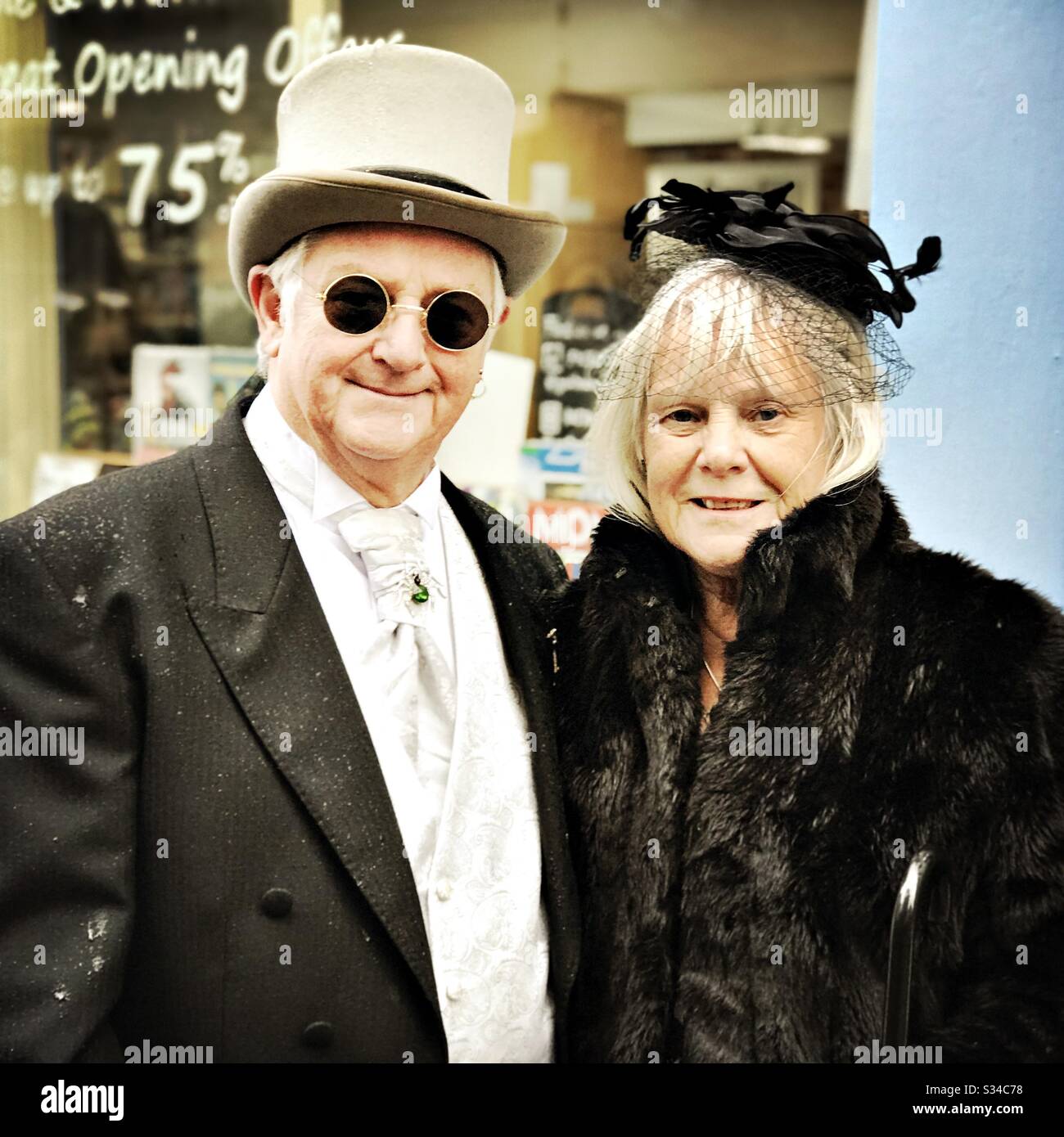 People in creative costumes during a cosplay event. Whitby Goth Weekend. Elderly couple, man and woman, wear vintage gothic outfits - Smartphone Captured Stock Image