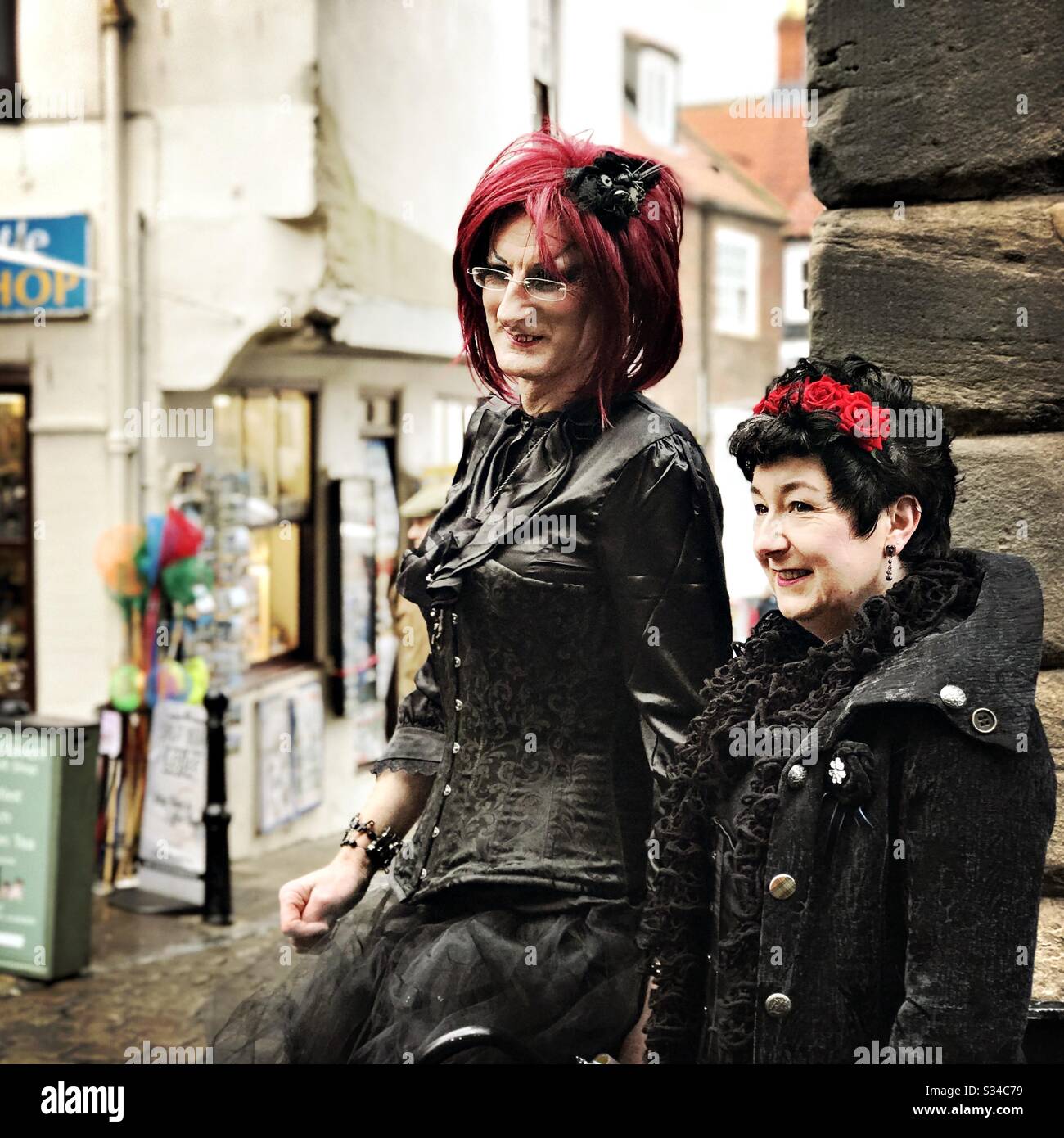 People in creative costumes during a cosplay event. Whitby Goth Weekend. Gothic couple in street - Smartphone Captured Stock Image