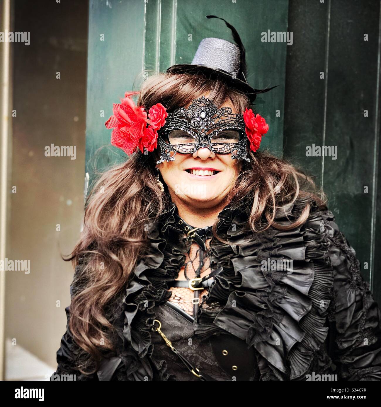 Person in a creative costume during a cosplay event. Whitby Goth Weekend. Confident Caucasian woman wears vintage gothic outfit - Smartphone Captured Stock Image
