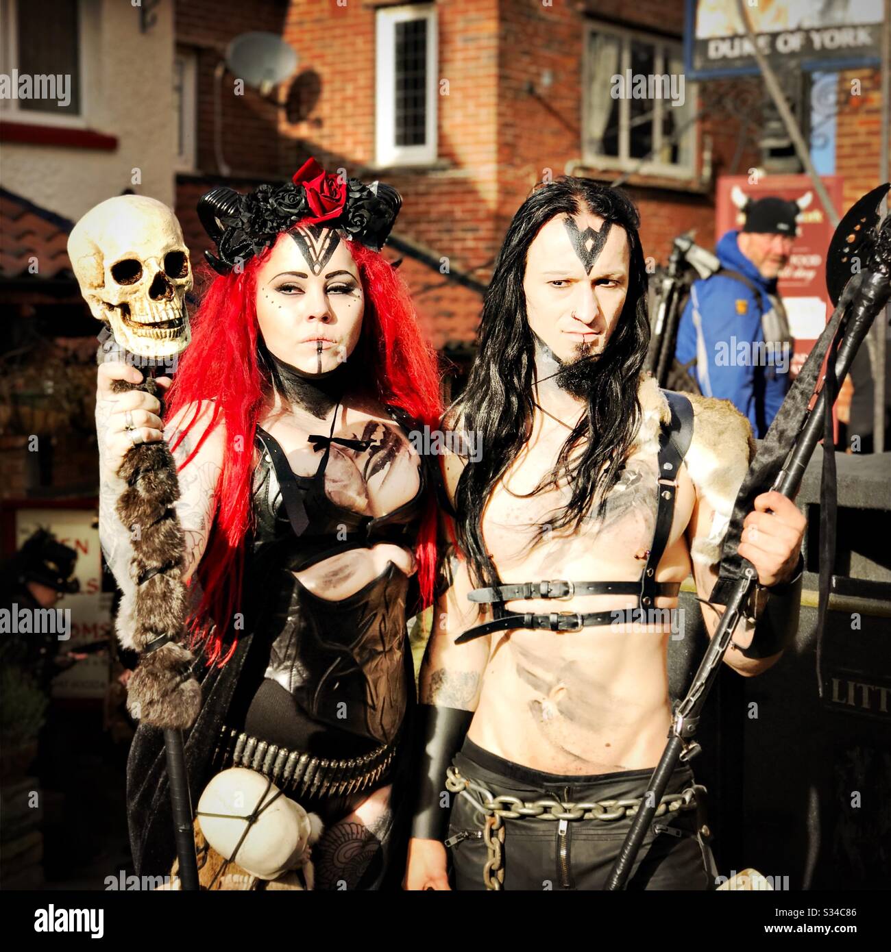 People in creative costumes during a cosplay event. Whitby Goth Weekend. Man and woman with skull staff - Smartphone Captured Stock Image