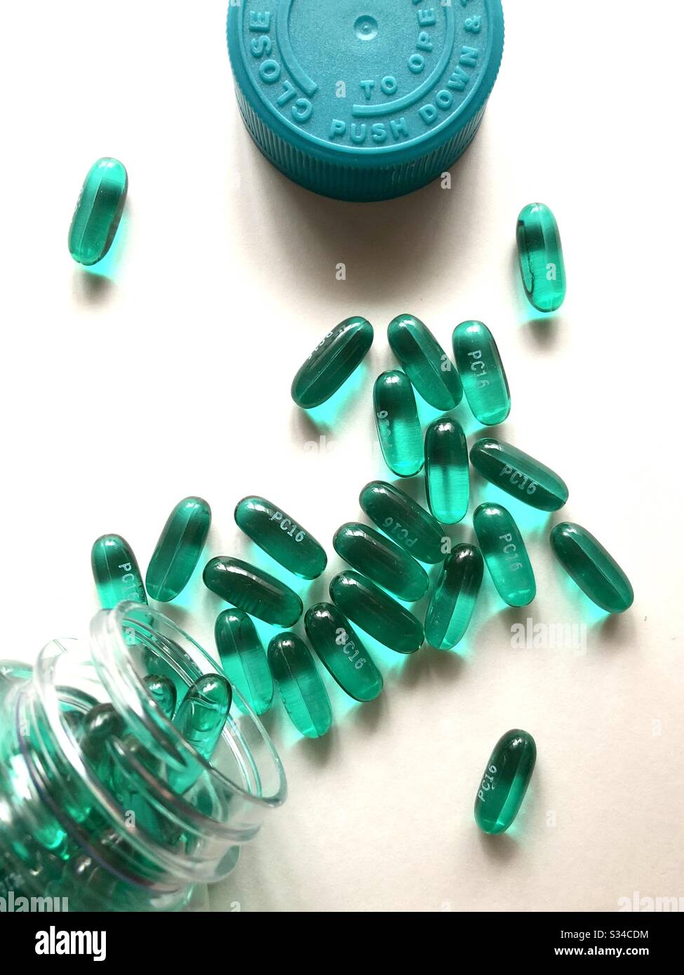 Ibuprofen capsules spilled on a white surface, top down view - Smartphone Captured Stock Image