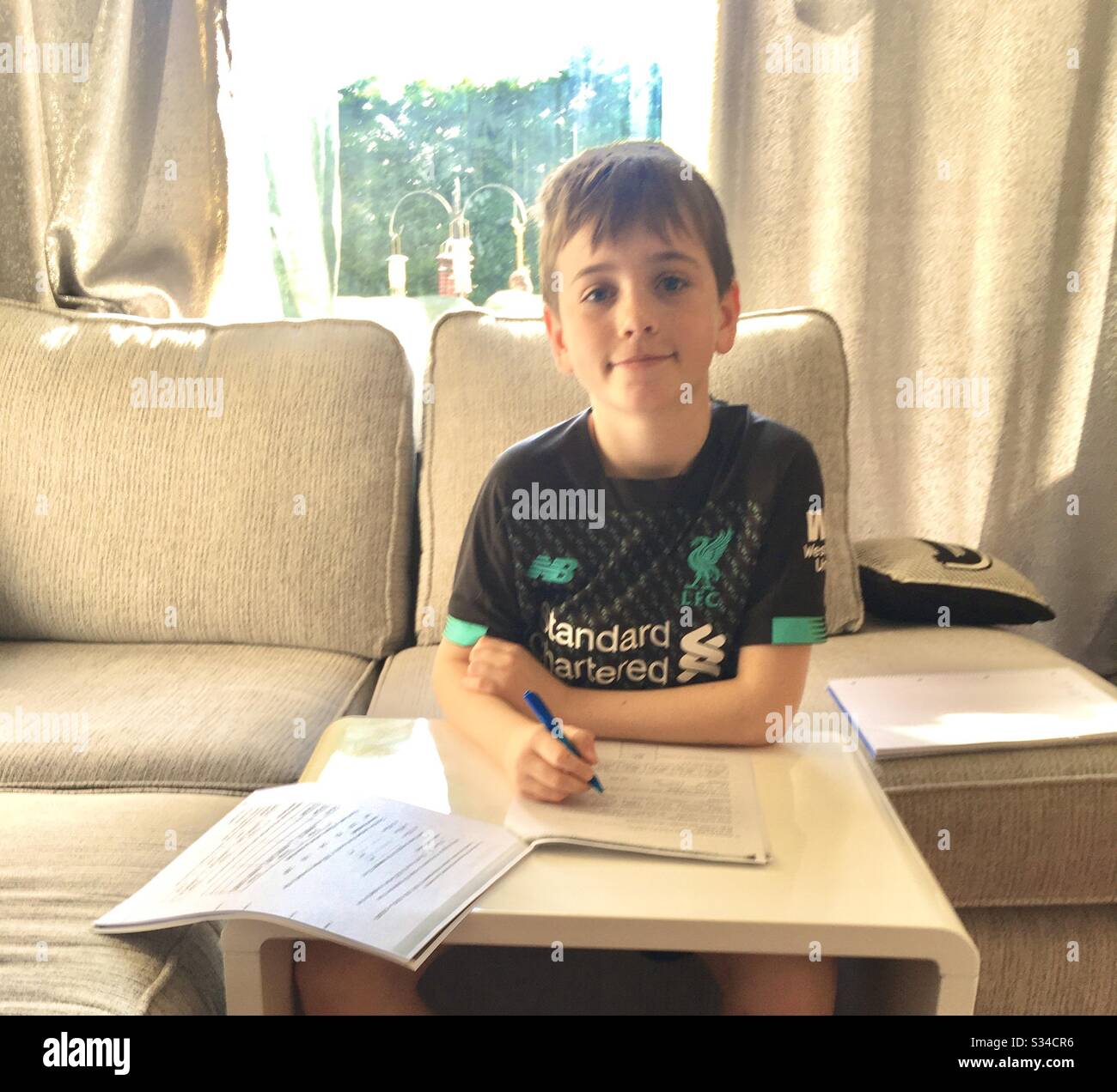Boy doing schoolwork at home - Smartphone Captured Stock Image