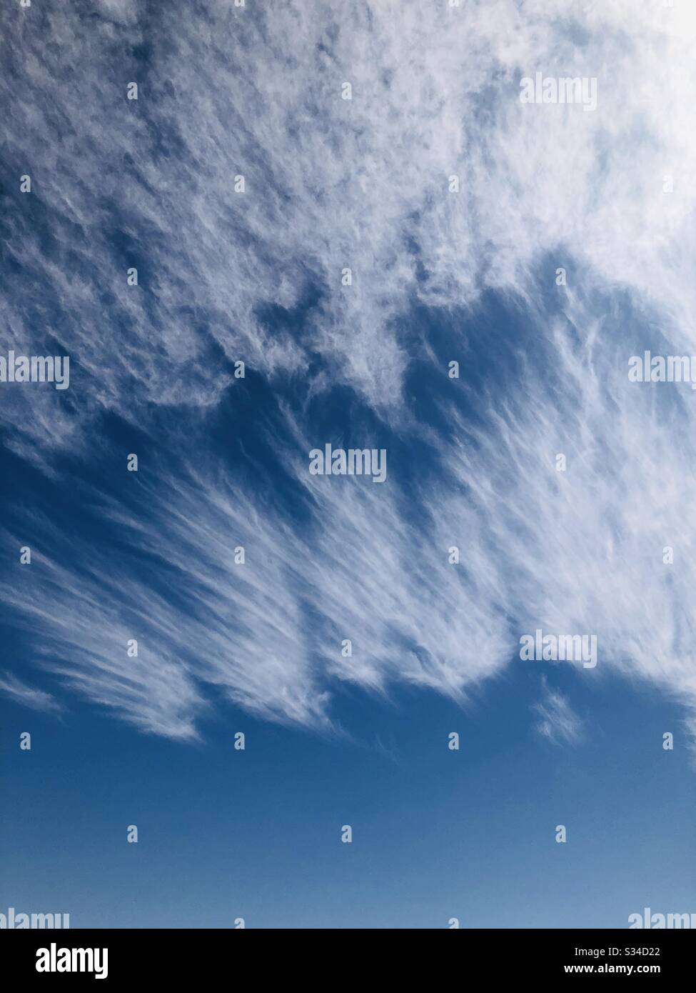 Copy space, blue sky, strange clouds, natural or unnatural, spring, upward angle, texture, YumaAZ Stock Photo