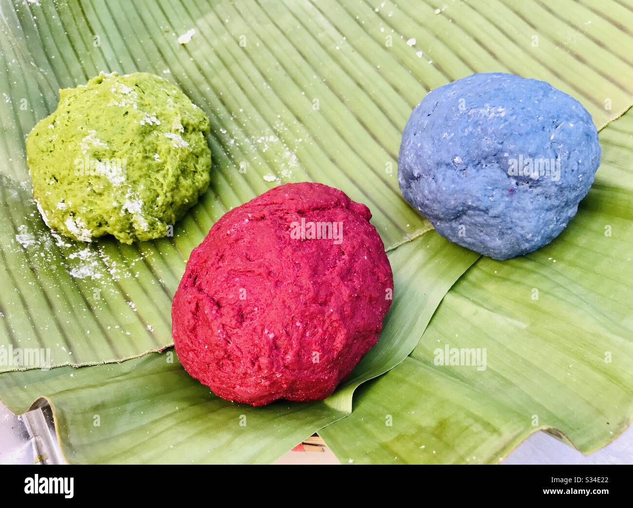 Healthy eats from scratch. Corn flour are used to make the noodle base, naturally tinted with nature using malunggay (moringa), beetroot and blue pea. Creative food preparation. Stock Photo