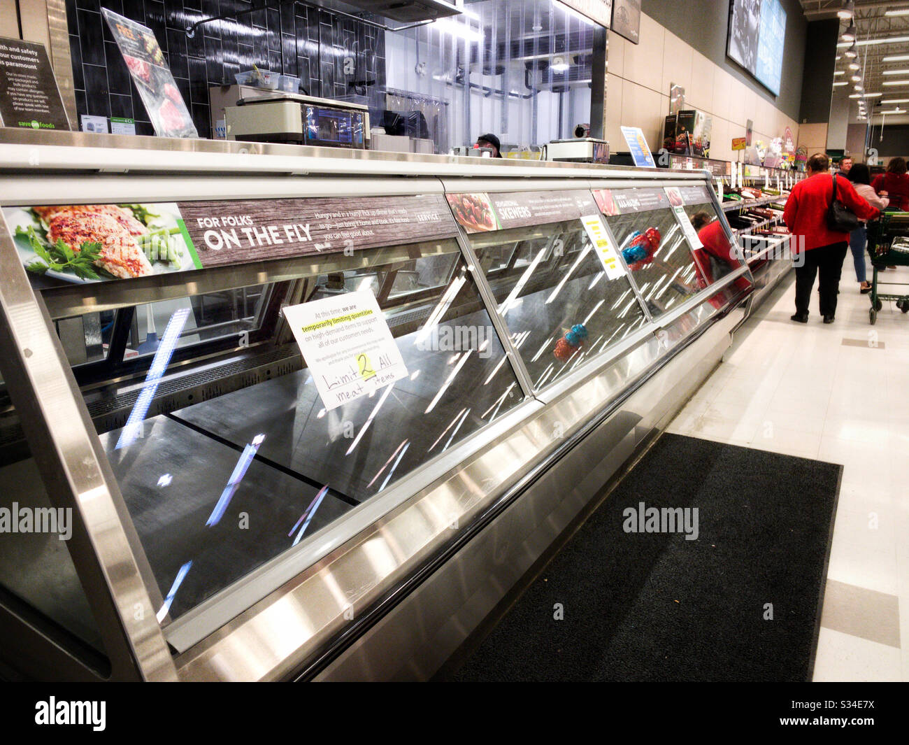 Surrey, Canada - 25th March, 2020: Empty meat counter at large grocery store during time of Coronavirus pandemic. - Smartphone Captured Stock Image