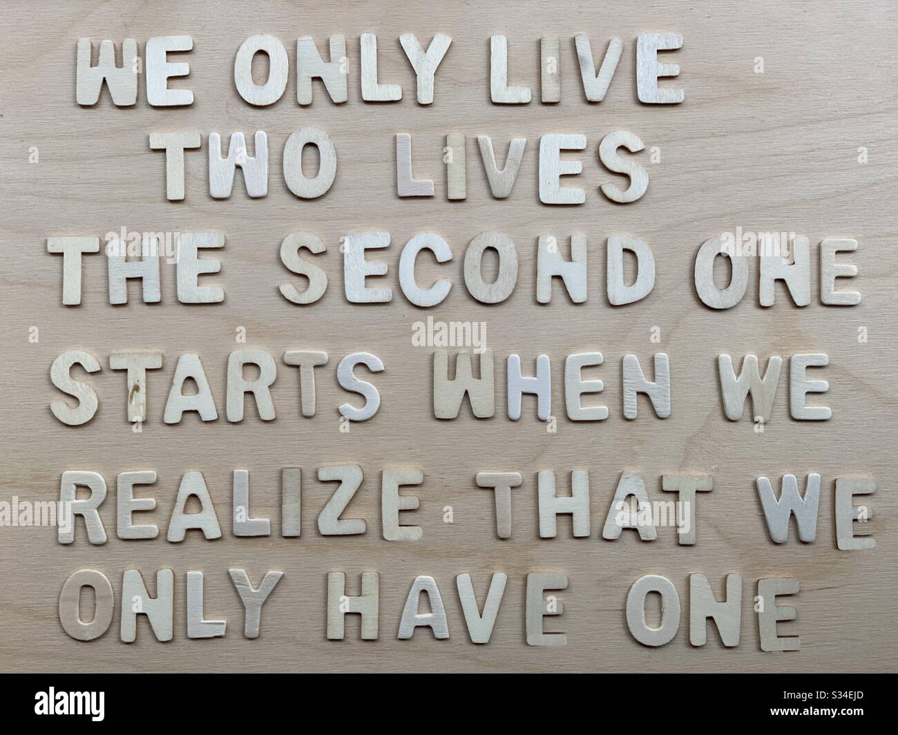 We only live two lives, the second one starts when we realize that we only have one - Smartphone Captured Stock Image