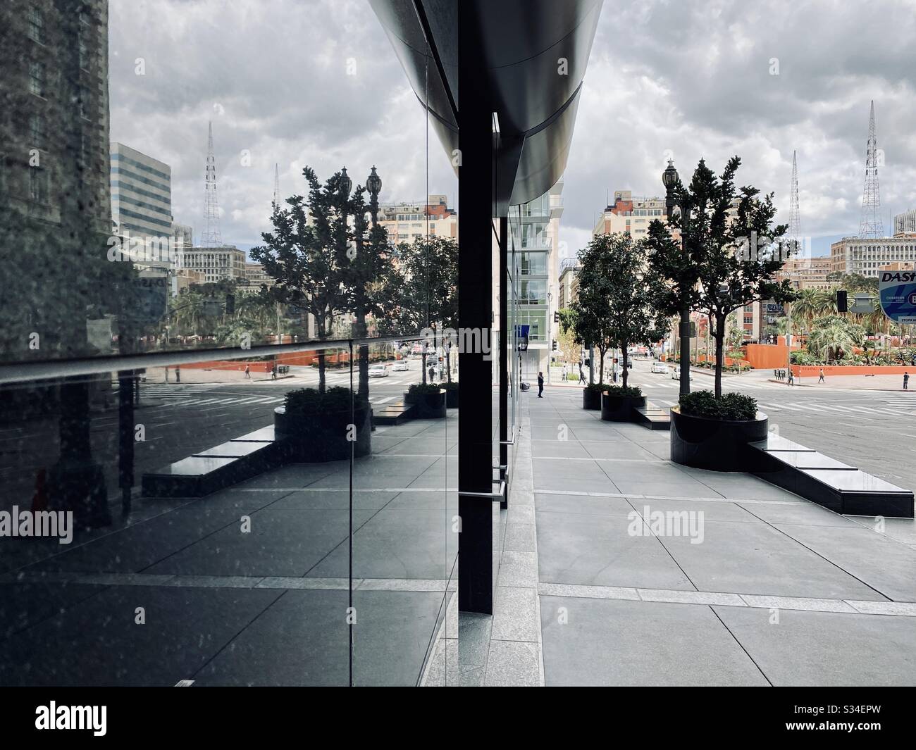 LOS ANGELES, CA, MAR 2010: ground level at The Gas Company Tower, looking towards Pershing Square in Downtown. Street reflected in building on overcast day. KRKD antennae in background. - Smartphone Captured Stock Image