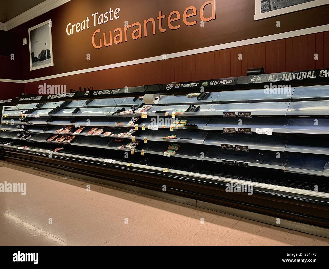 Empty meat shelves in grocery store. Stock Photo