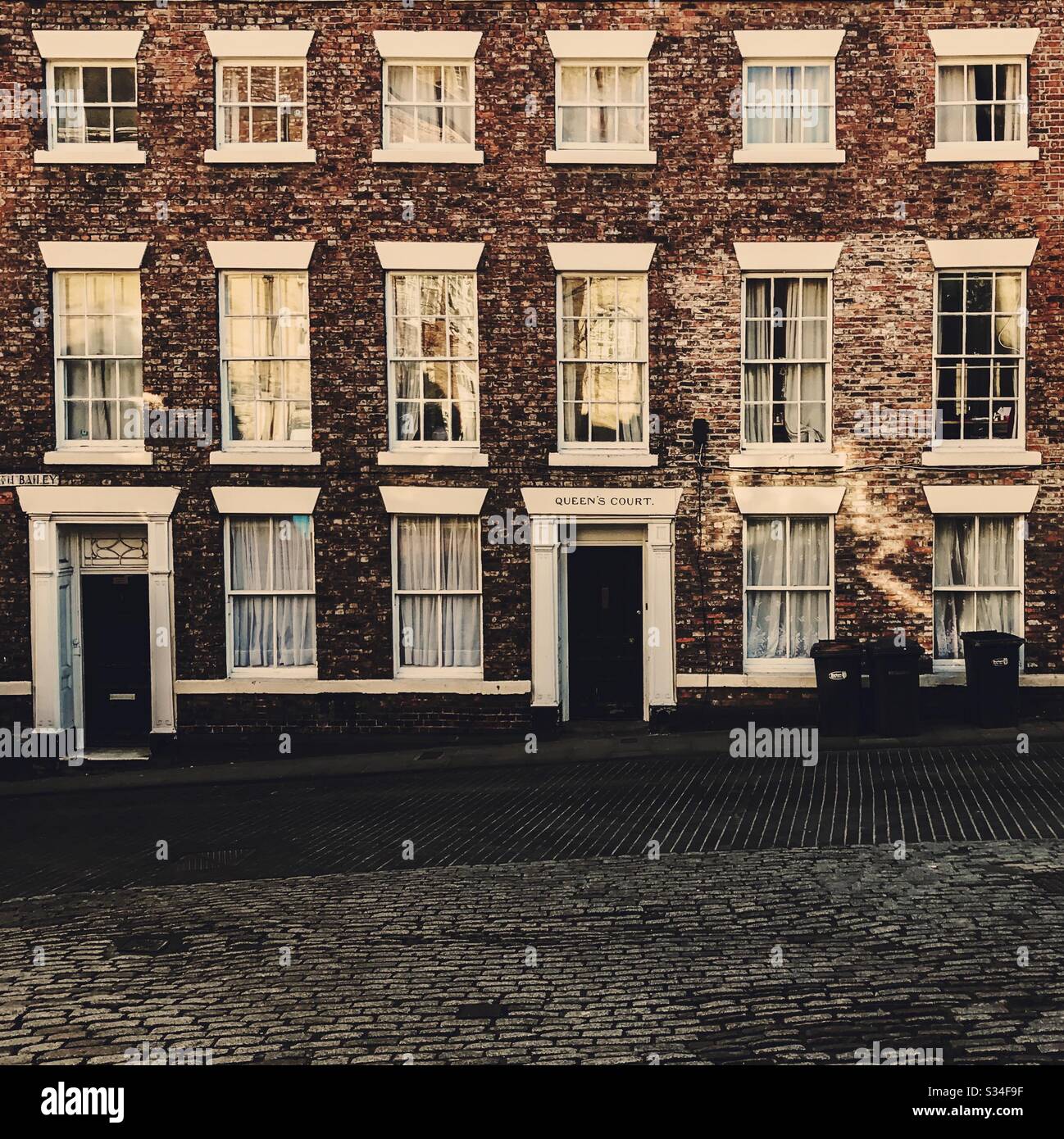 Architecture of Durham City, North East England. Old brick architecture with white stone sills and lintels with Georgian sash windows. Queen’s Court, Saddler Street - Smartphone Captured Stock Image