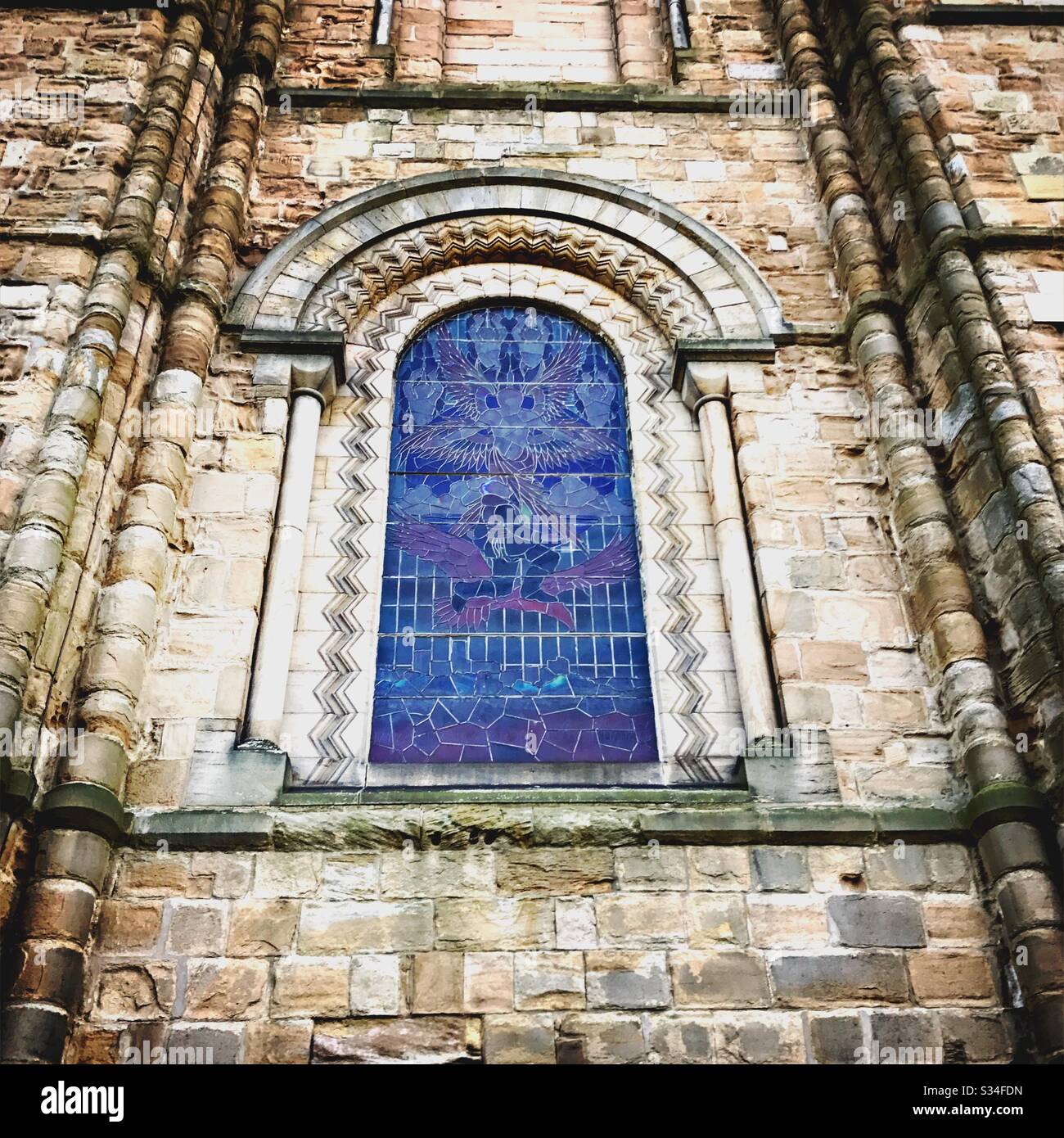 Architecture of Durham City, North East England. Historic stained glass window and gothic architectural elements at Durham Cathedral - Smartphone Captured Stock Image