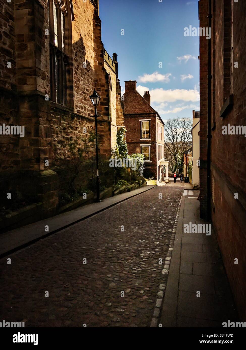 Architecture of Durham City, North East England. Quaint medieval backstreet with cobbled road on Bow Lane leading to Kingsgate Bridge, Durham - Smartphone Captured Stock Image