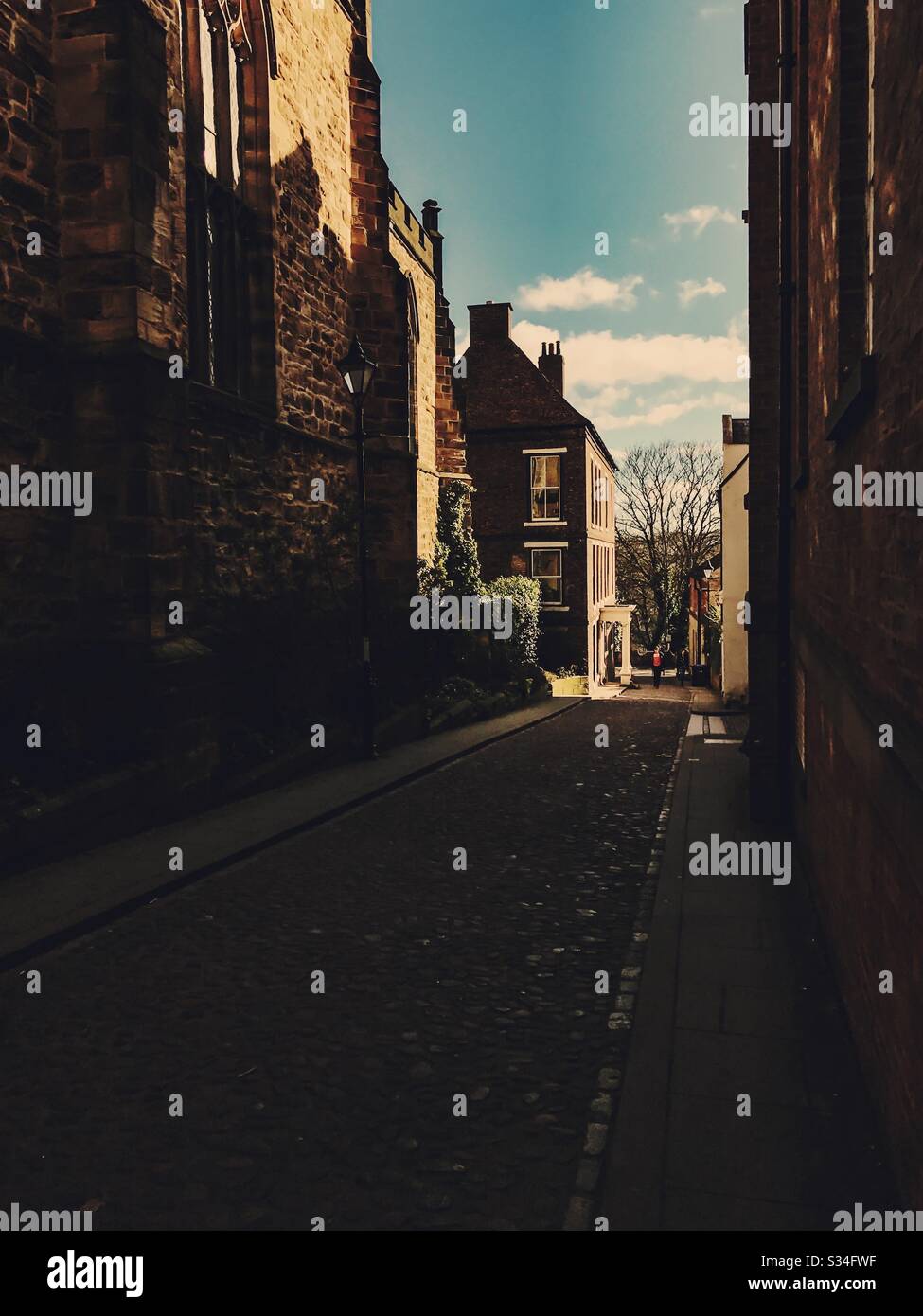 Architecture of Durham City, North East England. Quaint medieval backstreet with cobbled road on Bow Lane leading to Kingsgate Bridge, Durham - Smartphone Captured Stock Image