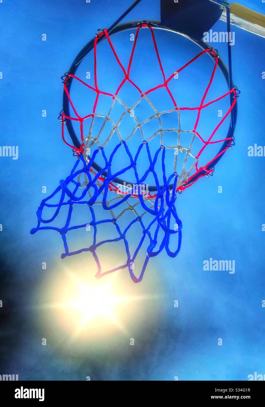 Basketball hoop and sun against blue sky - Smartphone Captured Stock Image